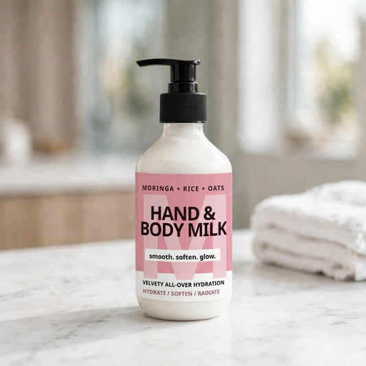 Hand and Body Milk pump bottle on a bright bathroom vanity