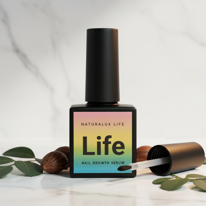 Natural nail growth serum on marble surface with moringa leaves and babassu nuts