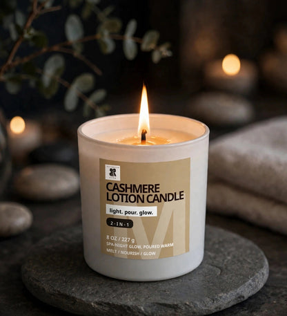 Cashmere Lotion Candle lit on a stone tray in a cozy evening spa setting
