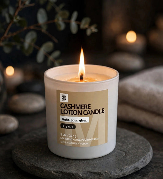 Cashmere Lotion Candle lit on a stone tray in a cozy evening spa setting